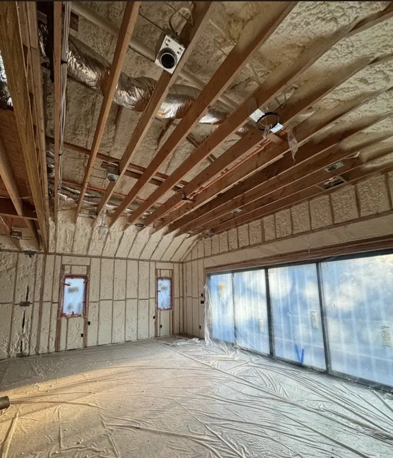 Interior walls and ceiling insulated with spray foam during new construction in Manorhaven